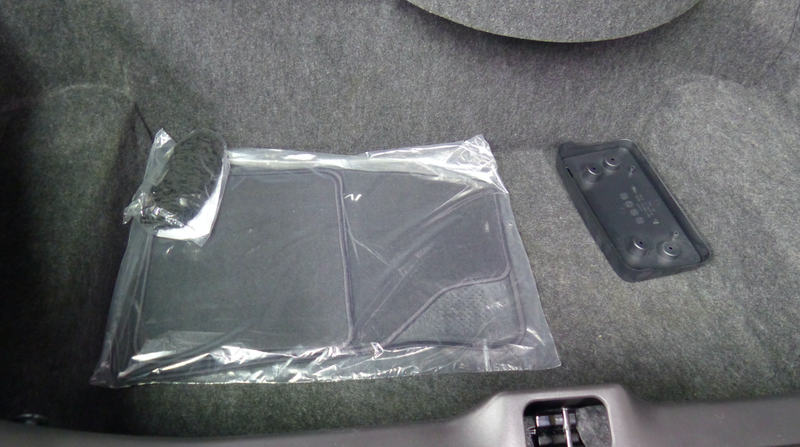 The rugs and cargo net are still in their original plastic wrap.